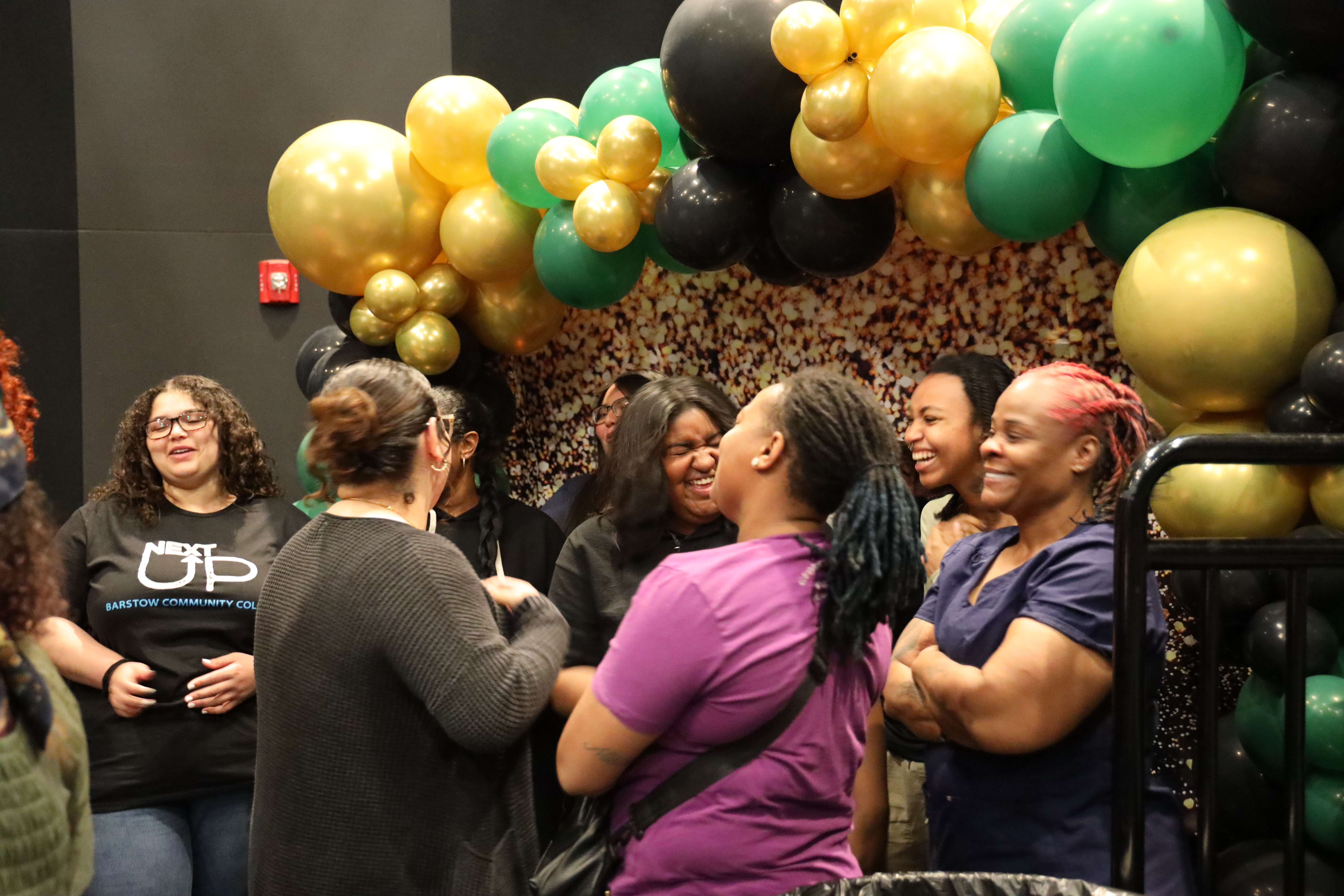 Shades of Sisters students laughing together during a campus event